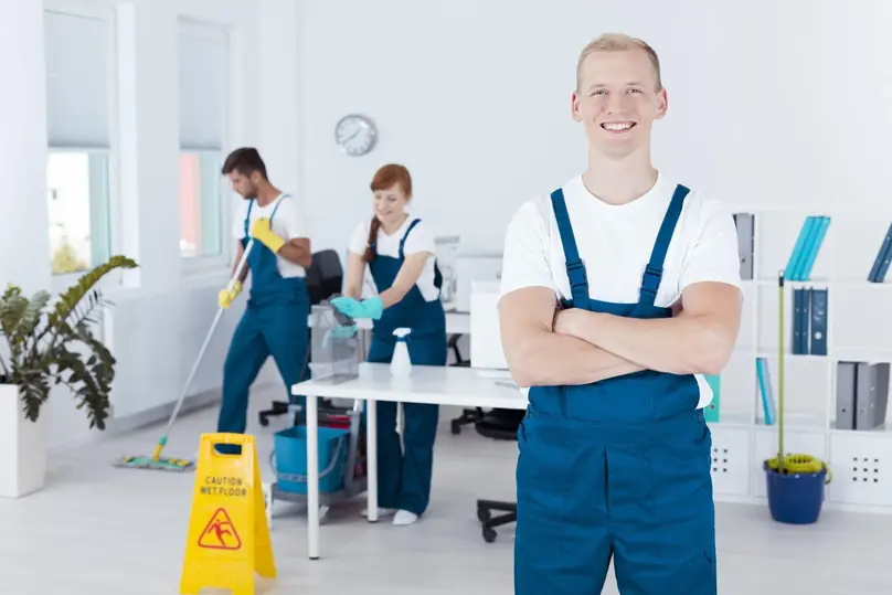 Professional cleaning team following office cleaning best practices in a shared workspace