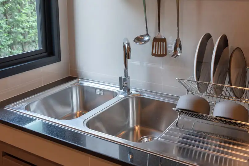 modern stainless steel sink area showing surfaces needing care on how to clean stainless steel sink