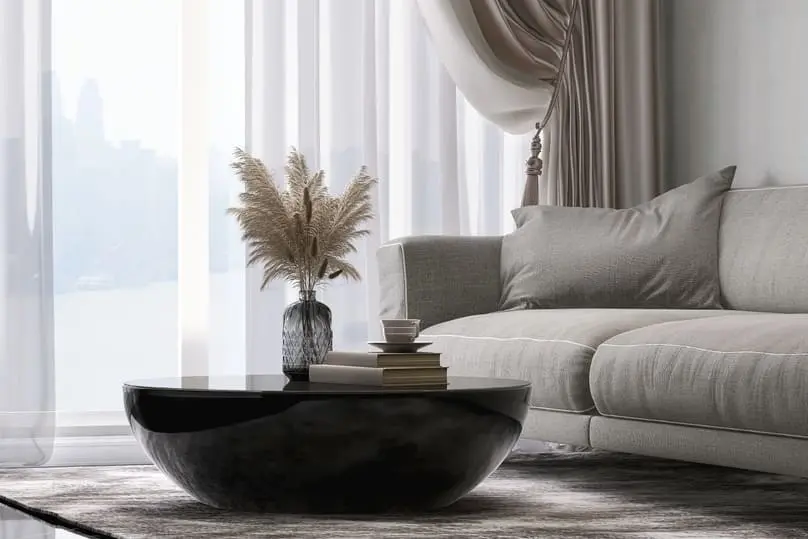 Bright living room highlighting curtains and guidance on how often to wash curtains.