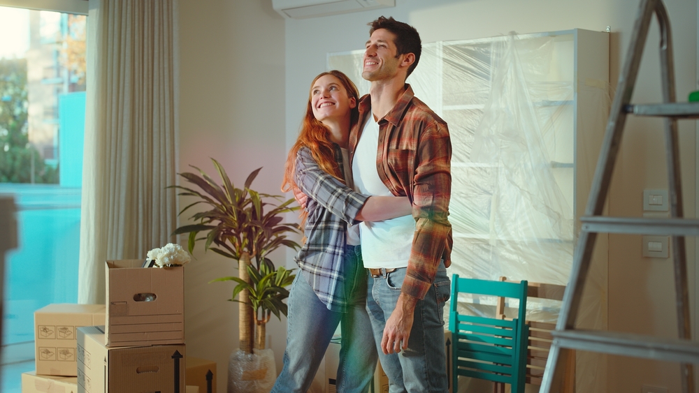 Happy couple admiring home after new construction cleaning.