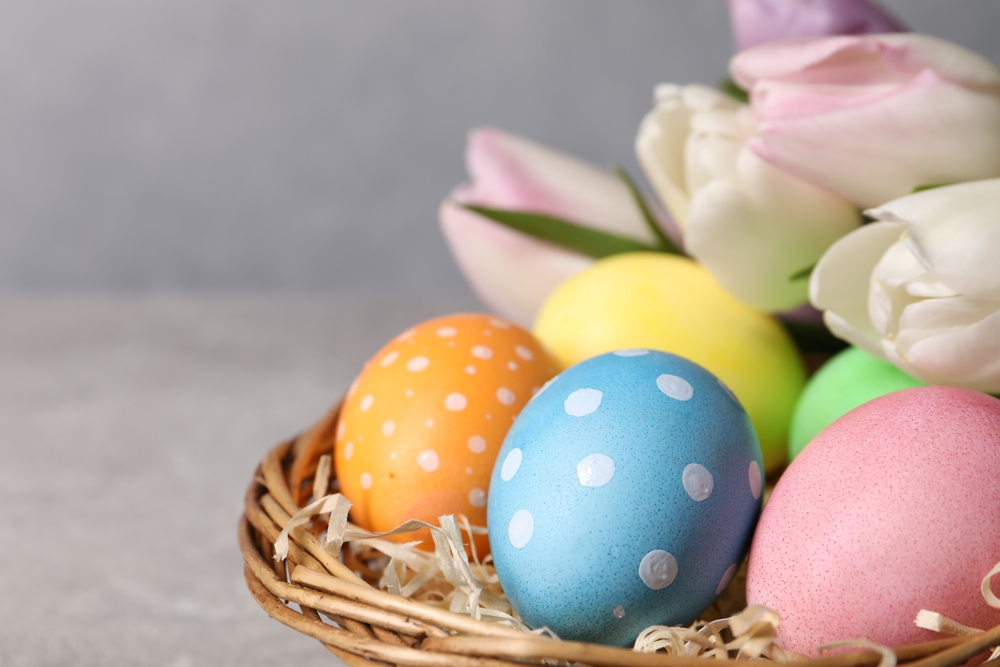 Colorful polka dot eggs in a basket; learn how to get easter egg dye off skin safely.