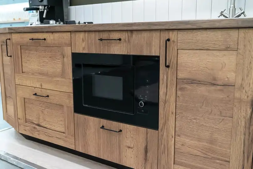 Modern kitchen showing spotless surfaces and how to clean wood cabinets properly.