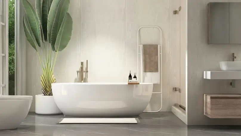 A sleek freestanding tub in a bright bathroom, showing how to get soap scum off bathtub surfaces.