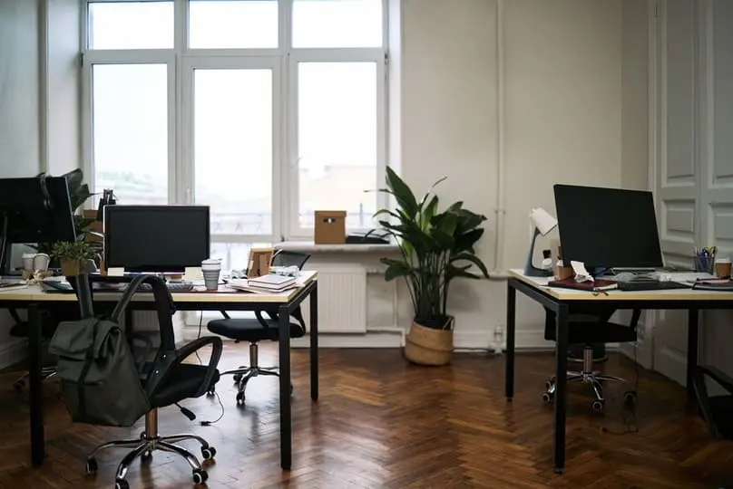 Cluttered modern office desks with computers show the importance of a clean workplace.